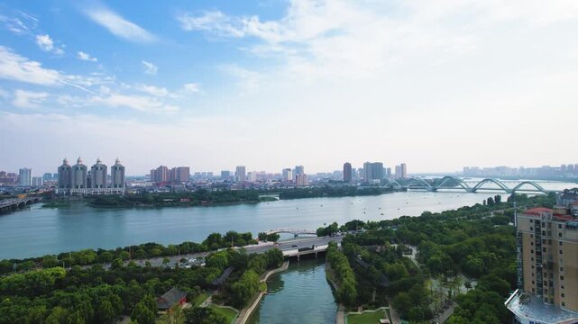 Riverside Park Urban Landscape with Bridge and City Skyline