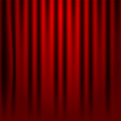 Large red curtain with spot light and fading into dark.
