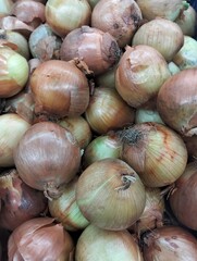 Fresh Brown Onions Piled Up at Traditional Market Background