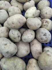 Piles of raw potatoes at the market 
