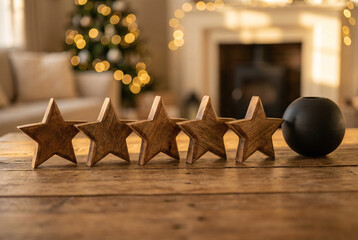 Five wooden stars with black ball on rustic table, customer review rating concept with negative feedback contrast.