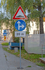 Direction Intersection Speed Bump Road Signs Pole Traffic in Town Centre