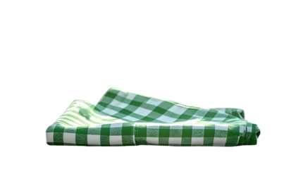 A close-up of a green and white checkered cloth folded against a black background