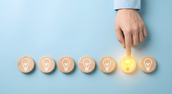 hand choosing different idea, glowing light bulb, inspiration concept