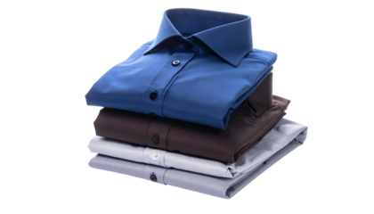 A neatly stacked pile of three folded shirts in varying shades of blue, brown, and grey