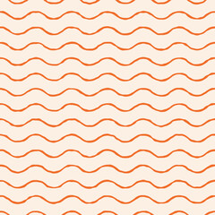 Orange hand-drawn wavy lines create a seamless pattern on a beige background. This abstract sea-inspired design works well for summer fabrics, wrapping paper, and coastal-themed decorations.