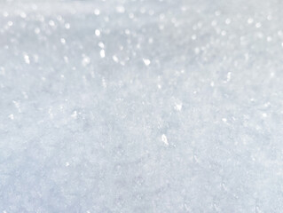 Sparkling white fresh snow texture background in sunlight
