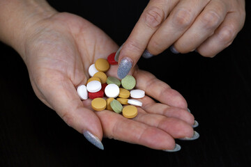 Pills in a hands of woman. Concept of antibiotics, vitamins, dietary supplements