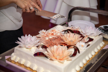 Osoba kroi tort na osiemnastych urodzinach, trzyma w ręku nóż © @tomasz_juchniewicz