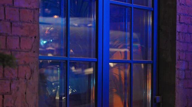 4k, A close-up view of the reflected light in the restaurant window from the warning lights of an ambulance, police car, fire truck, at nighttime