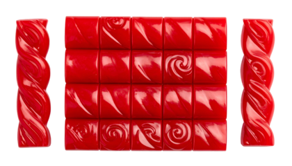Symmetrical composition of red, square candies & licorice twists on a black backdrop