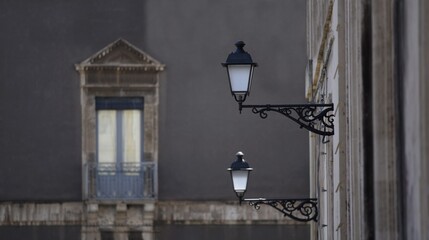 Traditional Victorian cast iron wall lanterns on the exterior of an old neoclassical building.  © ELENI MAVRANDONI