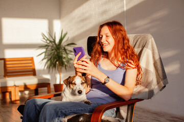 Teenage girl or young woman looks at phone at home