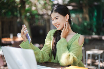 Beautiful confident asian young woman use smart phone college mobile addict spending time checking news technology e-commerce concept