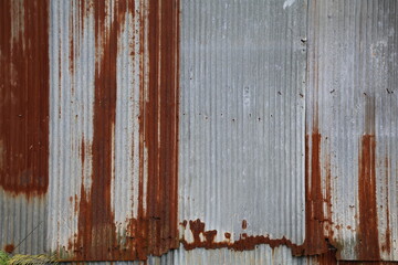 Old zinc surface background. Rusty metal texture. Weathered galvanize texture. Wavy rusty zinc pattern. Rusty tin background	