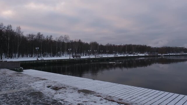 Pigeons walking along the snow-covered embankment of Lake Onega in Petrozavodsk, Russia