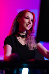 Young Female Gamer Enjoying a Colorful Gaming Session in a Neon Room