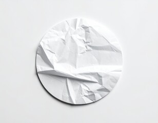 Crumpled white paper circle on flat, bright background
