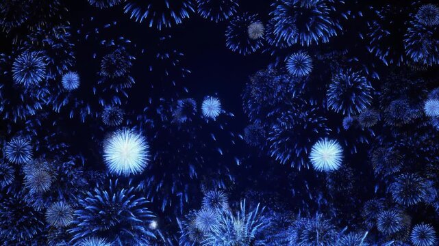 Brilliant sapphire blue fireworks exploding in the night sky with dramatic light bursts