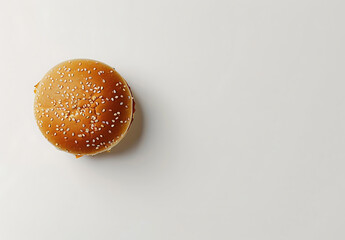 A burger with sesame seeds on top of the bun on white