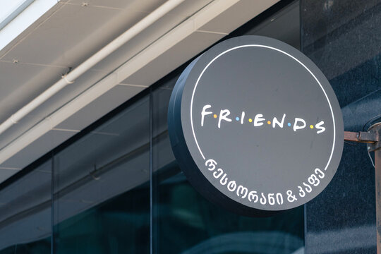 5 November 2025, Batumi, Georgia: Circular cafe sign with famous Friends TV show lettering and Georgian script on a building exterior in the city