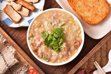 Brown rice porridge served with side dish on the table. 