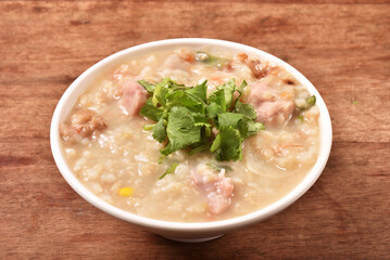 Brown rice porridge served with side dish on the table. 