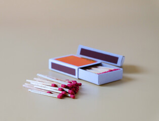 Pile of Wooden unused match stick in red box over the color background.