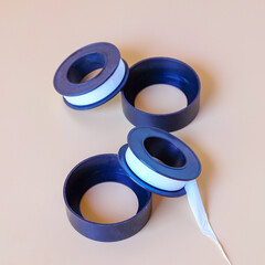 A seal tape roll or Pipe wrapping tape and cover on color background.