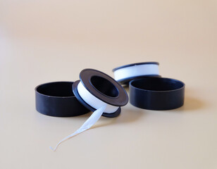 A seal tape roll or Pipe wrapping tape and cover on color background.