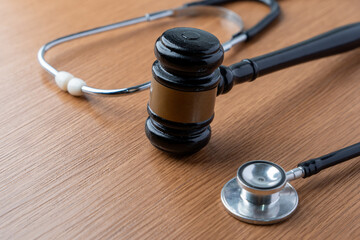 Conceptual image of a judge's gavel and a stethoscope. Medical law, malpractice litigation, healthcare regulations, forensic medicine concept.