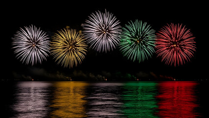 Vibrant fireworks display over water at night