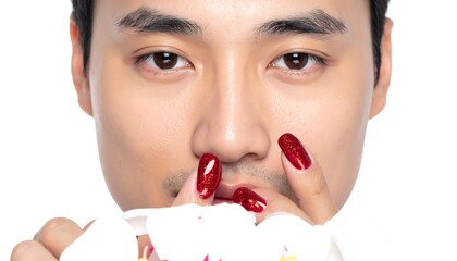 Close-up of a person with dark hair, a light complexion, and red glitter nail polish, partially obscuring the face with a flower