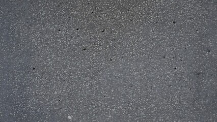 A blurry gray textured surface with speckled pattern and unclear details