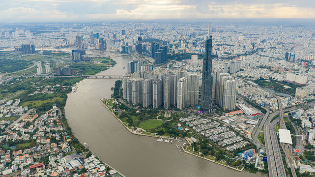 Aerial sunr view at Landmark 81 - it is a super tall skyscraper and Saigon bridge with development buildings along Saigon river, cityscape in the morning