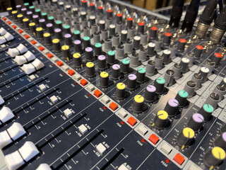 Sliders and volume knobs on DJ control panel. Concept of music control at event. Professional sound designer control panel. Adjusting sound and volume. Multicolored volume controls