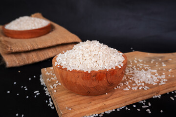 rice in a wooden bowl on wooden tray