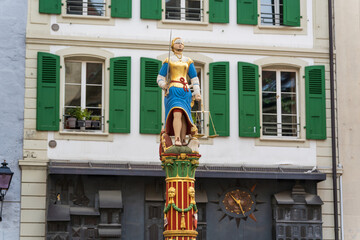 Lausanne, Vaud, Switzerland - November 01, 2025 : Fontaine de la Justice colorful statue at Place de la Palud.