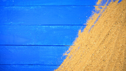 Sand on blue wooden. Sea summer vacation background with space for the text. Top view