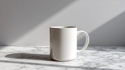Blank white ceramic mug placed on marble tabletop, set against light gray wall with soft light and shadow; minimalist empty drinkware, neutral tone background for product display, mockup.