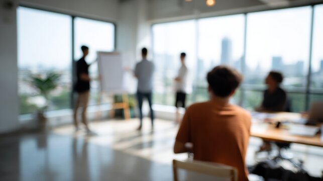 Modern office meeting with presenter at flipchart and colleagues listening in bright open workspace, collaborative discussion and brainstorming session in daylight - Powered by Adobe
