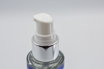Minimal cosmetic pump bottle on white background closeup.