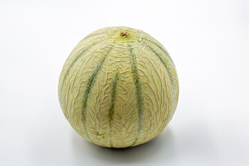 Whole cantaloupe melon on white background closeup.