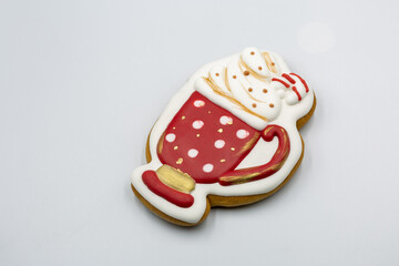 Decorated Christmas cookie shaped like hot chocolate mug closeup.