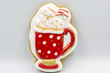 Decorated Christmas cookie shaped like hot chocolate mug closeup.