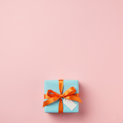 Holiday background with pastel pink backdrop, one wrapped gift box centered 