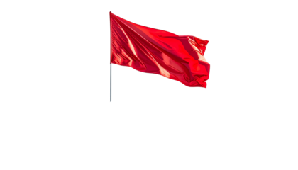 A vibrant red flag, silhouetted against a stark black background, blowing in the wind