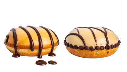 Two glazed donuts with chocolate drizzle and decorative elements on black