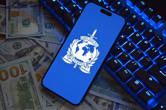The smartphone with Interpol logo displayed on screen. International Criminal Police Organization or Interpol.