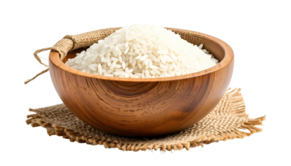 A wooden bowl overflowing with uncooked white rice, set on a rustic jute mat